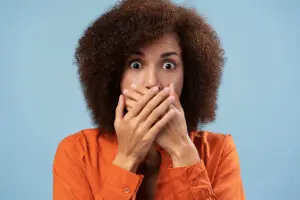 woman covering mouth out of concern root canal topic